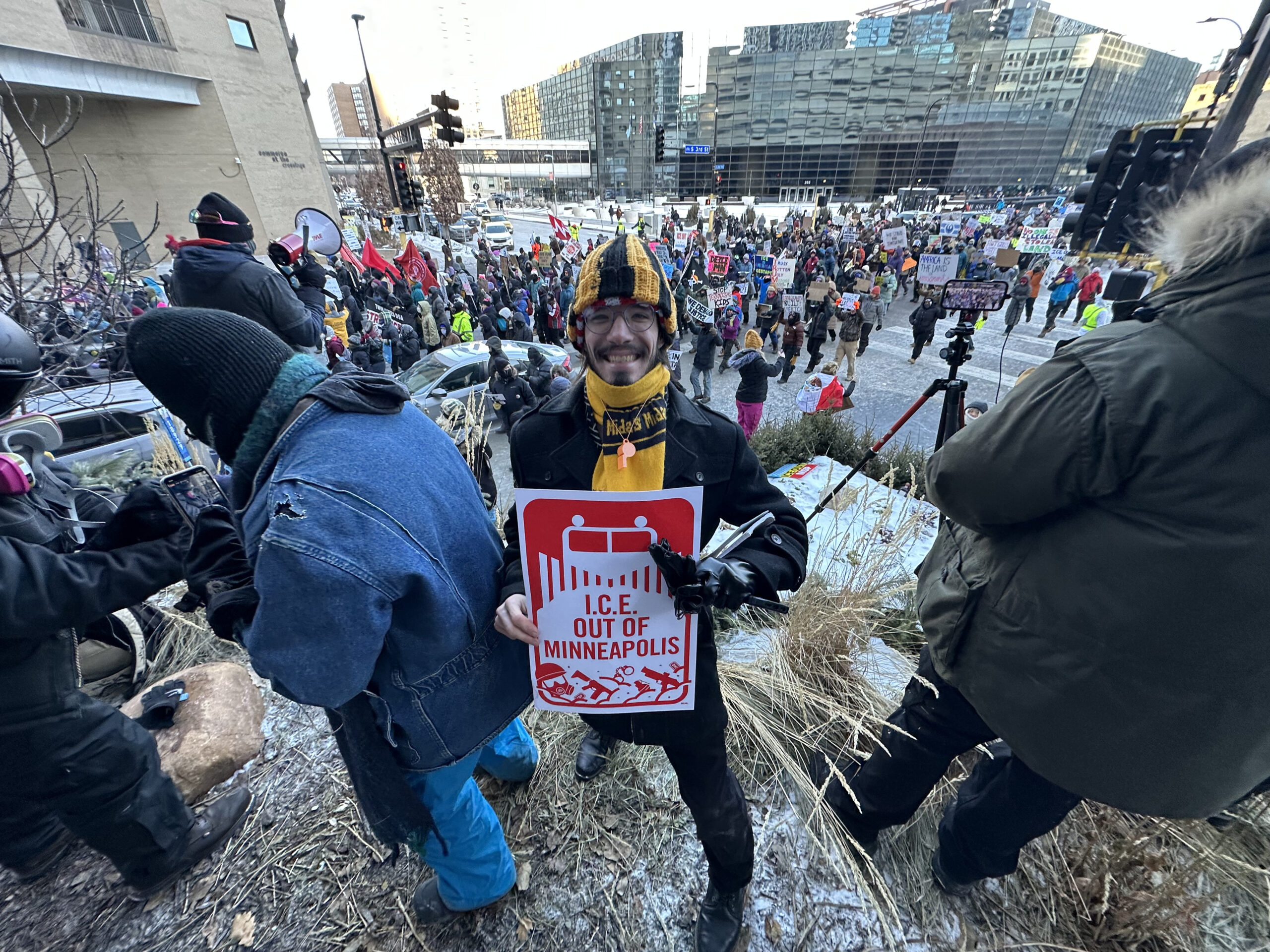 Cleveland DSA member Russell K holds a sign reading "ICE Out of Minneapolis" during the ICEOUT rally of January 23rd.
